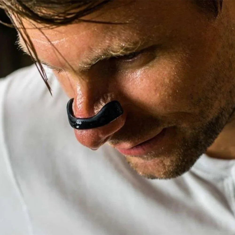 Man wearing Airoze magnetic nasal strip for improved breathing during workout or recovery