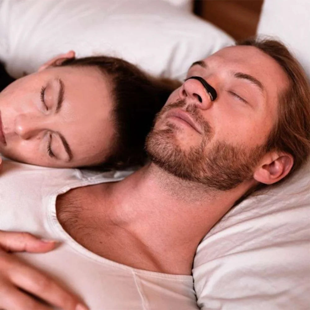 Man sleeping with Airoze magnetic nasal strip for snoring relief and better nighttime nose breathing solution